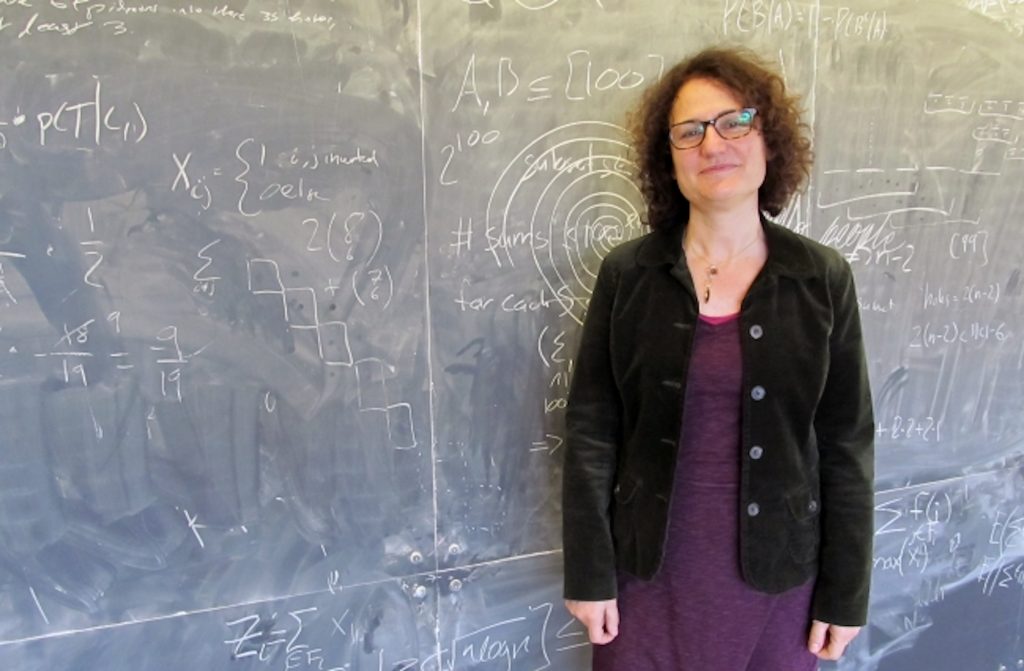 Gigliola Staffilani stands in front of a blackboard.