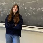 woman in front of blackboard